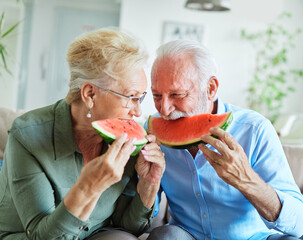 senior woman man couple love elderly watermelon fruit eating food fun togetherness summer cheerful happy smiling together enjoyment healthy eating fresh sharing
