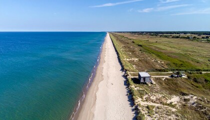Aerial View of Serene Beach and Coastline Under Clear Blue Sky