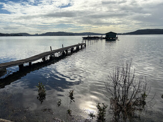 Fototapeta premium Lake view with wooden jetty and wooden hut.