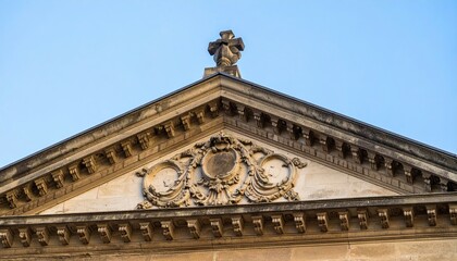 Fototapeta premium Ornate Architectural Detail with Cross on Historic Building Top