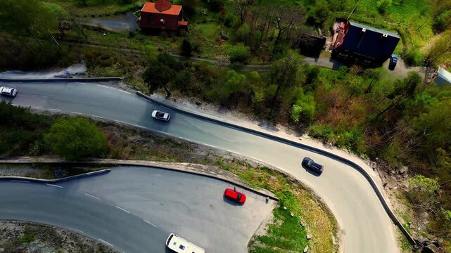 An amazing winding road with a beautyful view over the fjord surrounded by mountains.