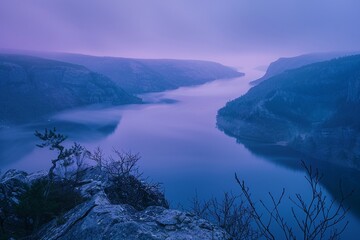 Majestic mountains mirror their grandeur in the calm lake waters under a vibrant sunset sky