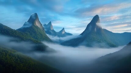 Fototapeta premium A misty mountain range in the early morning, with low-hanging clouds and fog swirling around the peaks, creating an eerie atmosphere.