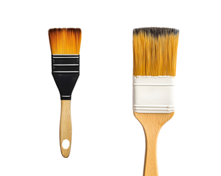Close-up view of two paintbrushes, one black and one with gold bristles, differing in size