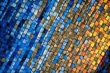 Vibrant mosaic wall with dynamic wave pattern in orange and blue tones