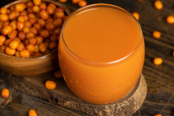 sea buckthorn berries and a glass of sea buckthorn juice, a glass of natural orange juice and frozen sea buckthorn berries