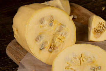 cut white squash on the kitchen table during cooking and slicing, close up