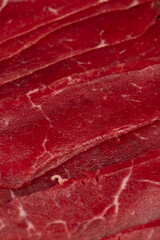 beef jerky without cooking, beef dishes cut into thin slices and eaten raw, closeup