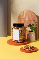 Assorted nut snacks in transparent packaging, blank product labels, baked healthy delicacies