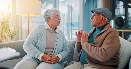 Obraz premium Home, sofa and senior couple with fight in marriage, argument and disagreement in living room. Couch, elderly man and old woman with conflict for toxic relationship, breakup and anger for divorce