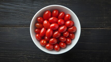 Fresh, ripe cherry tomatoes in a white bowl.