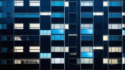 Fototapeta premium Symmetrical Urban Architecture with Blue Window Lights on Contemporary Building