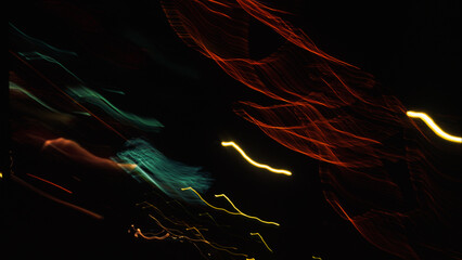 Abstract blurred dark background with traces of night lights.