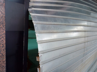 Close-up of rolling shutter smashed and shop robbed