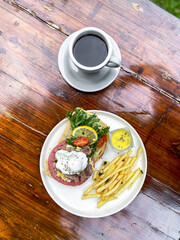 Vertical full plate of Open Sandwich with egg, fries, and smoked beef, ready for online sales.