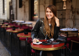 Young stylish girl model walks around the city of Milan.