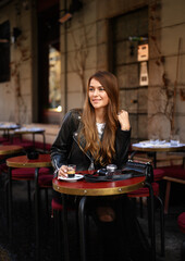 Young stylish girl model walks around the city of Milan.