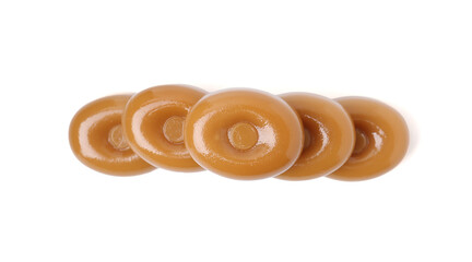 Tasty hard toffee candies isolated on white, top view