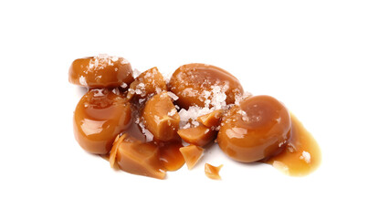 Tasty sweet candies, salt and caramel sauce isolated on white