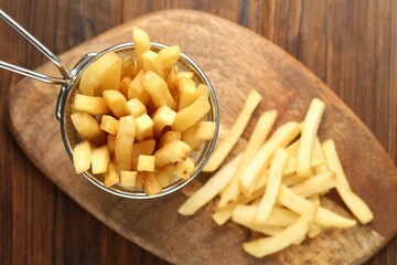 Tasty french fried served on wooden table, top view
