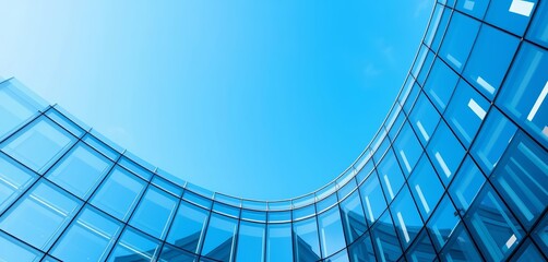 Glass corner of modern office building, clear blue sky, modern, reflection