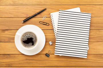 Notebook with stationary on wooden background, top view