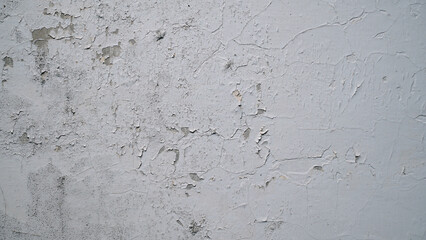 White wall with cracked and peeling surface