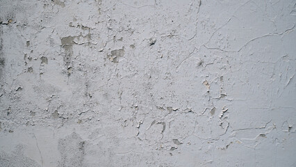 White wall with cracked and peeling surface