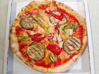 Vegetarian pizza with vegetables served in a cardboard box