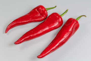 Ripe sweet red Kapia peppers on a gray background