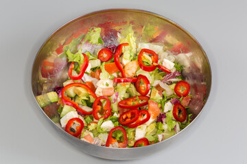 Salad with avocado, cheese and different fresh vegetables and lettuce