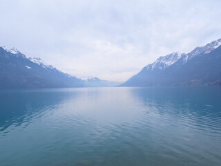 A view of the Brienz lake in Winter with the swiss Alps in the background. Brienz, Switzerland - February 10, 2025. 