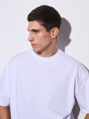 Fototapeta premium Male model in a T-shirt on a white background.