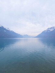 A view of the Brienz lake in Winter with the swiss Alps in the background. Brienz, Switzerland - February 10, 2025. 