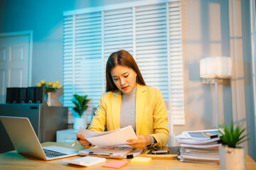 Exhausted businesswoman works late into the night, overwhelmed by stress, deadlines, and endless...