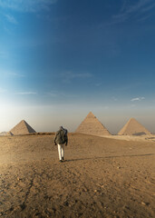 Photograph of a tourist at the Pyramids of Giza. Trip to Egypt.