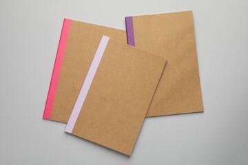 Different copybooks on grey background, flat lay