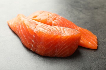 Seafood. Pieces of salmon fillet on gray table, closeup