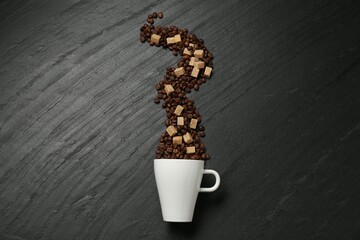 Aromatic coffee beans, brown sugar and cup on black table, flat lay