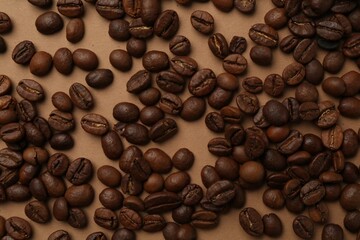Aromatic coffee beans on beige background, flat lay
