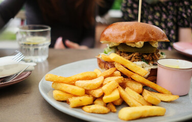 Big Meat Burger With Chips In Family Fast Food Restaraunt