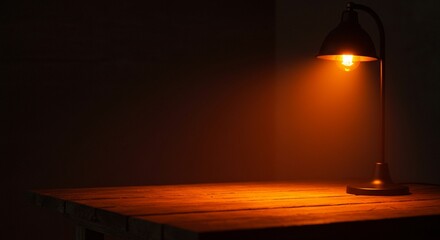 Warm Glow of Inspiration: Rustic Wooden Table Illuminated by a Vintage Desk Lamp in a Dark Room. High quality professional stock photo suitable for commercial use.