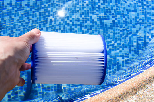 Generative Image of a Swimming Pool with a Tiled Bottom. Replacement Pool Filter Cartridge in Hand on a Water Backdrop. Sun Beam. Copy Space. 