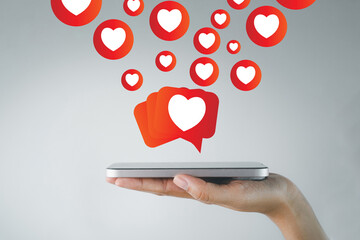 Mobile phone with heart-shaped reaction icons floating above, representing social media engagement, likes, and emotional responses, ideal for digital marketing, social platforms, and online campaign.