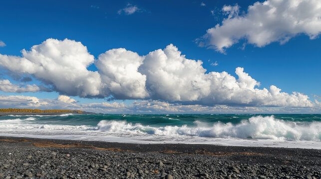 A dramatic beach scene with crashing waves, a rocky shore, and a clear blue sky.