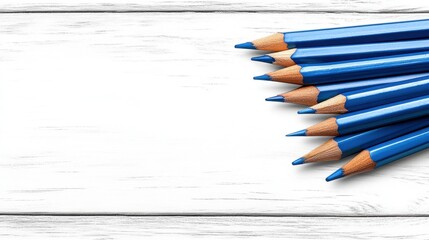 Obraz premium Blue Pencils on White Wooden Background with Copy Space
