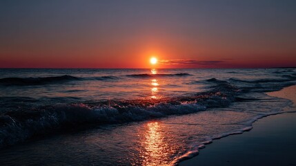 Naklejka premium Sunset casting an orange glow across the horizon, where the sea meets the sky, reflecting beautifully on the water's surface