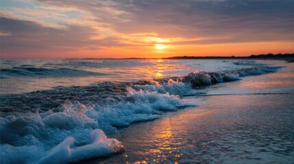 Obraz premium The horizon lit by a stunning orange sunset, with the sea glowing in vibrant colors and soft waves lapping at the shore