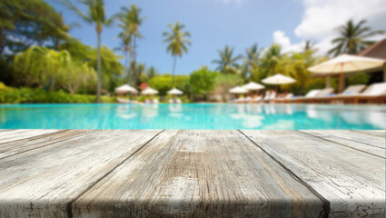 Relaxing poolside setting with palm trees and lounge chairs on a sunny day in a tropical resort environment