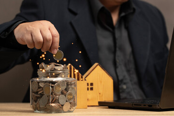 Man putting coins in a jar full of savings. The goal of real estate investing and using technology for financial management and informed decision making. Strategic planning and long term investment.